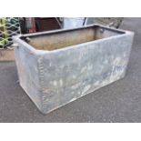 A rectangular riveted galvanised water tank with flat rim. (48in x 24in x 24in)