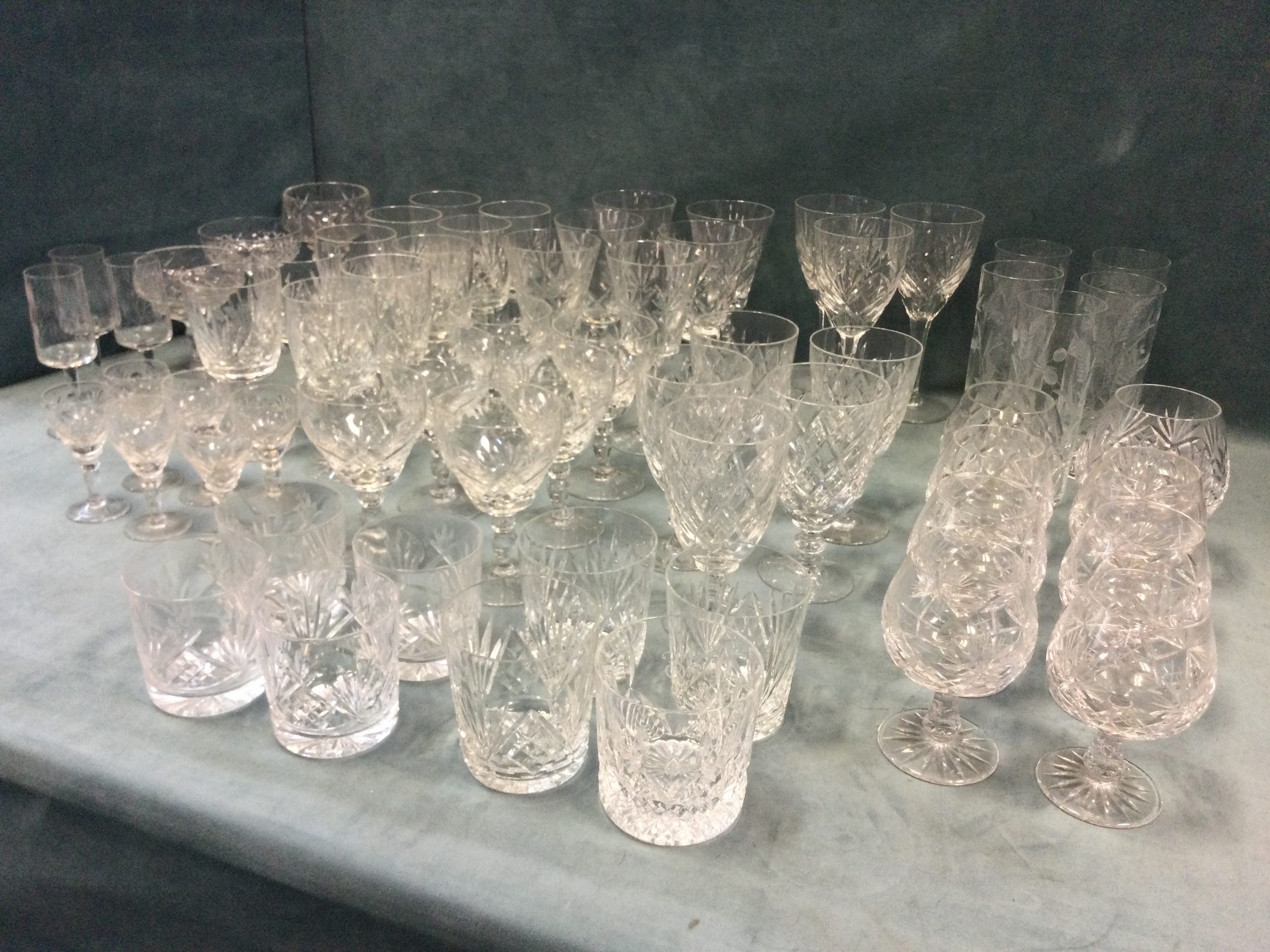 A quantity of drinking glasses - Edinburgh cut crystal, tumblers, wine glasses, brandy balloons,