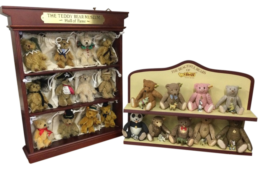 A collection of nine Steiff ceramic bears on a The Beautiful Bears of Steiff stand, the