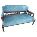 A late Victorian mahogany arts & crafts style sofa with rectangular padded back and arms above a