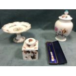 Four pieces of Coalport porcelain - a floral comport in the Ming Rose pattern, a square tea caddy in