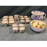 A quantity of Indian Tree coffee and tea cups, with milk jug; a blue & white floral chamber pot; and