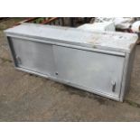 A rectangular stainless steel wall cabinet with two sliding doors. (58.75in x 11.75in x 22.5in)
