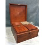 A square nineteenth century mahogany caddy box with four lidded hinged compartments having brass