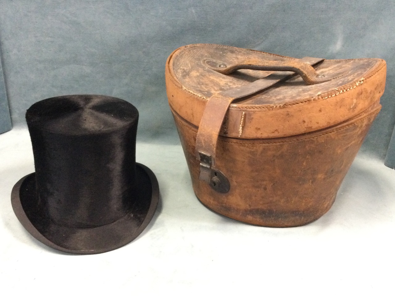 A Victorian leather cased silk top hat by Lock & Co, the brass lock engraved CR Hemingway, St Colms,