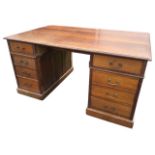 A late Victorian oak partners desk with rectangular moulded top above frieze drawers, raised on