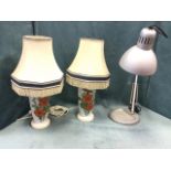 A pair of milk glass floral handpainted tablelamps on wood bases, fitted with octagonal fringed