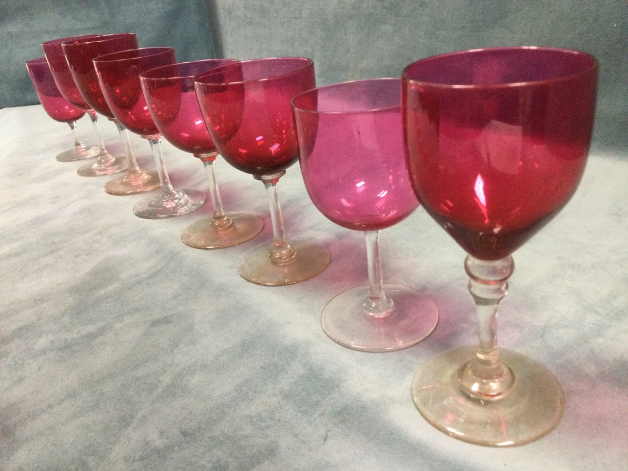A set of sixteen cranberry wine glasses on clear stems with circular bases - varying shapes & sizes. - Image 2 of 3