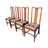 A set of four Norman Shaw Edwardian mahogany dining chairs with indented back rails above plain