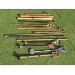 A collection of miscellaneous walking sticks, canes, three leather mounted shooting sticks and one