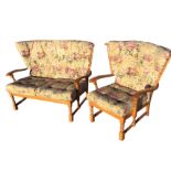 An Ercol style cottage sofa and armchair with button upholstered loose cushions and spindlebacks,