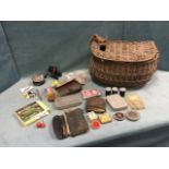 A cane fishing creel containing fly boxes & flies, a spinning reel, leather cast wallets with hooks,
