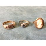 A Victorian 9ct gold ring inlaid with small rubies and seed pearls to scrolled panel; a small 9ct