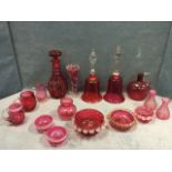 A collection of Victorian cranberry glass - a pair of bells, a decanter & stopper, an ovoid jug,