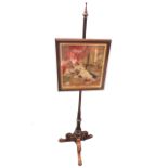 A Victorian rosewood firescreen, the column with turned finial above a banister with scroll carved