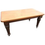 A Victorian oak dining table with fluted leaf carved legs on casters, having later thick canted pine