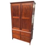 A reproduction mahogany press with angled cornice above panelled doors and four short drawers,