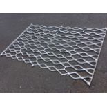 A rectangular painted wrought iron grill with waved bars to frame. (71.25in x 46in)