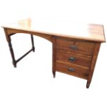 A mahogany desk with rectangular moulded top above a kneehole with arched apron, the side with a