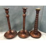 A pair of oak candlesticks with turned columns on saucer bases, have brass candle sconces - 12.75in;