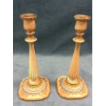 A pair of Royal Worcester blush ivory candlesticks with urn shaped candleholders above beaded