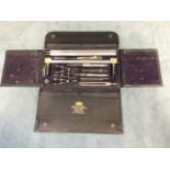 A cased geometry set by WH Harling, the named drawing instruments with protractors, dividers, rules,