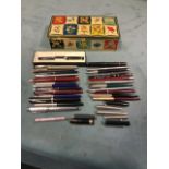 A tin of old fountain pens, propelling pencils, biros, etc., - Parker, marbled, Osmiroid, Pilot,
