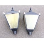 A pair of reproduction Victorian style lamppost tops, the square tapering lanterns above tubular