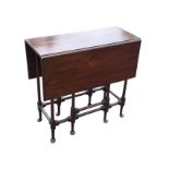 A nineteenth century mahogany spider-leg table with two drop-leaves on gates, raised on eight turned