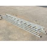 An extending aluminium ladder in three sections, each with ten ribbed triangular rungs. (109in