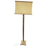 A brass standard lamp, the twisted column mounted with rectangular fabric shade, raised on square