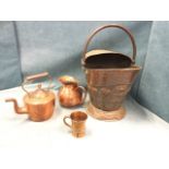An art nouveau floral embossed copper coal bucket with swing handle; a Victorian copper kettle &