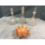 Three miscellaneous cut glass decanters & stoppers; and a carnival glass bowl embossed with