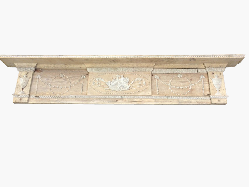 The top of a nineteenth century pine chimneypiece with mantlepiece above frieze with raised