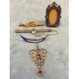 A 9ct gold mizpah bar brooch; a pierced scrolled pendant set with seed pearls and rubies; an