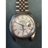 A Rolex oyster perpetual datejust gentlemans wristwatch, the engine turned bezel enclosing a white