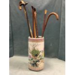 A famile rose style tubular porcelain umbrella stand decorated with peacocks and blossom foliage