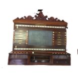A Victorian Burroughs & Watts snooker scoreboard, with an acanthus scroll carved crest above a