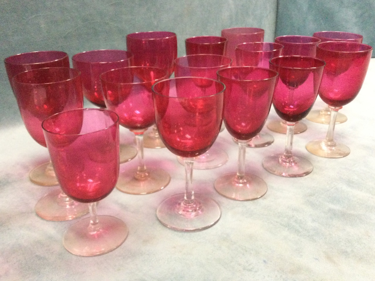 A set of sixteen cranberry wine glasses on clear stems with circular bases - varying shapes & sizes. - Image 3 of 3