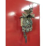 A Bavarian carved cuckoo clock with rabbit & bird framing dial with roman chapter ring, the