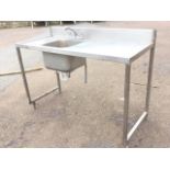 A tray-top stainless steel sink unit fitted with mixer taps, raised on square legs & stretchers. (