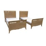 A pair of stained 3ft 6in single beads, the shaped headboards and tailboards with pierced fretwork
