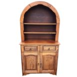 An oak old charm style dresser, the arched open shelves above two drawers and fielded panelled