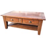 A rectangular pine coffee table, the cleated top above two frieze drawers mounted with brass cup