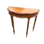 A yew side table with crossbanded scalloped moulded top above a frieze with applied panels and