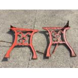 A pair of painted cast iron table supports with chanelled legs supporting scroll cast rails. (22.