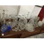 A collection of decanters & stoppers - some with silver labels on chains, claret jugs, bowls,