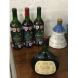 An unopened bottle of Bells commemorative 1990 whisky; a bottle of Tsantali rosé wine; and three