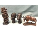 An African carving with pillar of entwined figures; a pair of carved African heads; and a carved