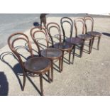A set of fice Czechoslovakian bentwood dining chairs, the hooped backs above circular press